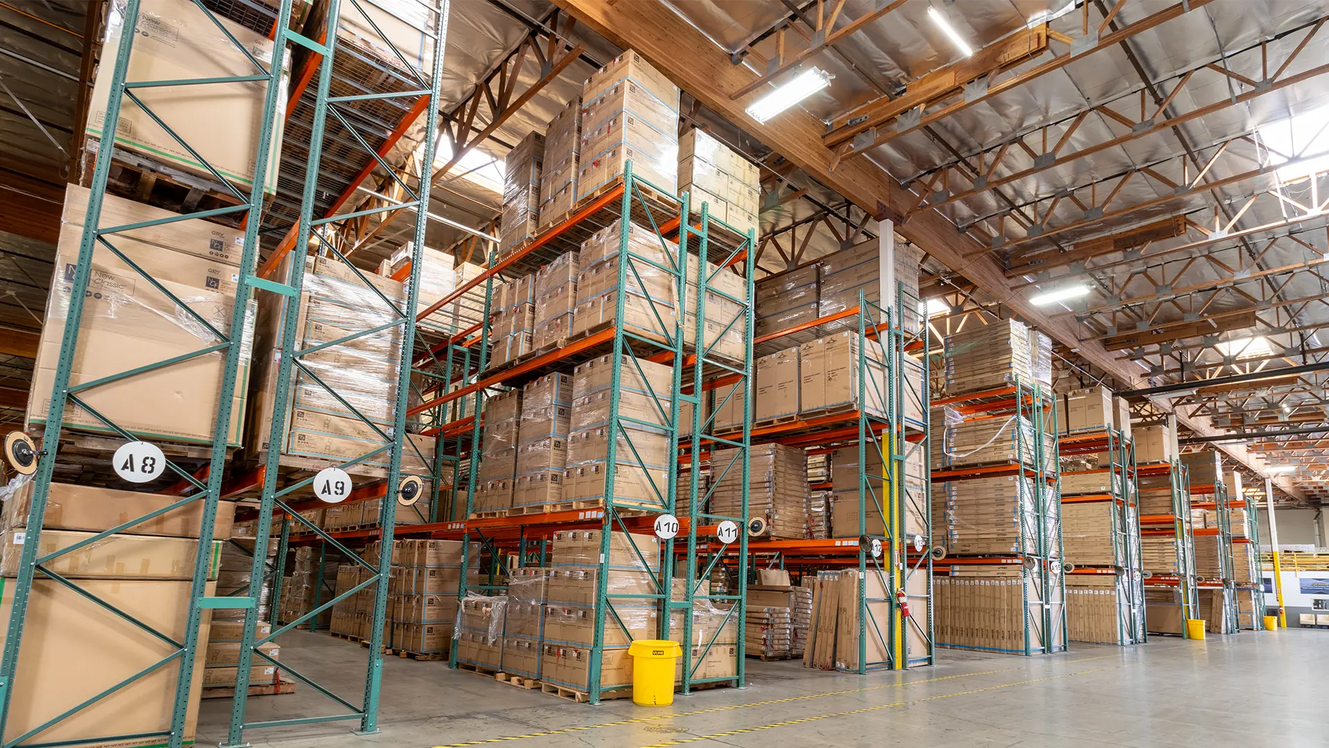 New Classic Furniture warehouse interior showing stacked pallets and organized distribution racks ready for nationwide delivery.